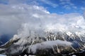 Snowy Mountains peaks in the clouds blue sky Caucasus