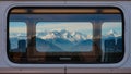 Snowy Mountains Reflected in Train Window During Winter Journey â AI content Royalty Free Stock Photo