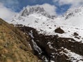 Snowy mountains, waterfall, clouds and sky. Mount Chaukhi Caucasus. Georgia