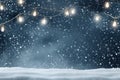 Snowy night with light garlands, falling snow, snowflakes, snowdrift for winter and new year holidays. Holiday winter landscape. Royalty Free Stock Photo