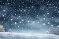 Snowy night with light garlands, falling snow, snowflakes, snowdrift for winter and new year holidays. Holiday winter landscape. Royalty Free Stock Photo