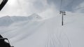 Snowy off-piste ski slope with ski and snowboard tracks on a sunny winter day. Freeride in high mountains Royalty Free Stock Photo