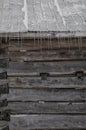 Snowy old log cabin barn with icicles background Royalty Free Stock Photo