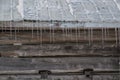 Snowy old log cabin barn with icicles background Royalty Free Stock Photo