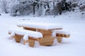 Snowy outdoor timber log table.