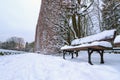 Snowy park scenery with empy bench Royalty Free Stock Photo