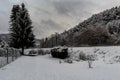 A snowy path with a tree between the fence and the train tracks Royalty Free Stock Photo