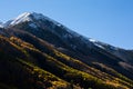 Snowy peak with changing leaves in Autumn Royalty Free Stock Photo