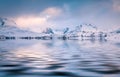 Snowy peaks reflected in the calm waters of Sandvika bay. Royalty Free Stock Photo
