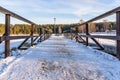 Snowy Photo of the Park on a Sunny Winter day - Wooden Footpath in the Middle of it, Concept of the Harmony and Travel Royalty Free Stock Photo