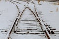 Snowy rails surrounded by a road railway in the winter landscape Royalty Free Stock Photo