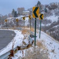 Snowy road with directional road signs in winter Royalty Free Stock Photo