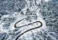 Snowy road in the forest. Extreme winding road high up in the mo Royalty Free Stock Photo