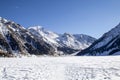 Snowy road between rock hills with snow. Royalty Free Stock Photo