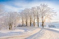 The snowy road in the woods Winter way after the snowfall through forest covered in snow. Beautiful sunny day with icy and frosty Royalty Free Stock Photo