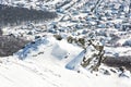 Snowy rocks, winter landscape and village in the valley