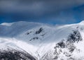 Snowy rocky mountains are well visible. Royalty Free Stock Photo