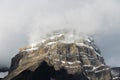 Snowy rocky summit in the clouds Royalty Free Stock Photo