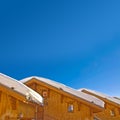 Snowy roofs of mountain wooden cabins