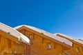 Snowy roofs of mountain wooden cabins