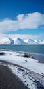 Captivating Coastal Scenery: Water And Snow Covered Mountains