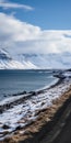 Scenic Gravel Road By The Sea: Capturing The Beauty Of Snowy Mountains