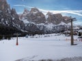 Snowy Slope and a view of the Surrounding Landscape of the Snow-covered of the Italian alps Dolomites Mountains, Colfosco, Italy Royalty Free Stock Photo