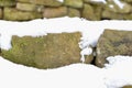 Snowy stone wall. Stones covered with snow. Royalty Free Stock Photo