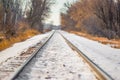 Snowy straight railroad tracks near the Minnesota River and near Black Dog coal power plant