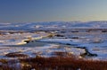 Snowy stream highlighted by evening sunlight, Langahlid, Iceland