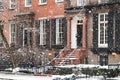 Snowy street scene with the historic buildings along Washington Square Park during a winter noreaster storm in New York City