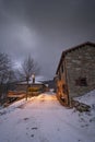 Snowy street with a street light on the sidewalk in the medieval village of La Hiruela