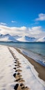 Transcendent Adventure: Snow-covered Beach With Majestic Mountain Ranges