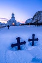 Snowy sunrise in Iceland, featuring crosses at the front of a beautiful church