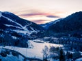 Snowy sunset in the mountains of Andorra with ski slopes. Royalty Free Stock Photo