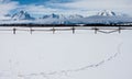 Snowy tetons western fence and pure snow with line of tracks Royalty Free Stock Photo