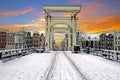 Snowy tiny bridge in Amsterdam the Netherlands in winter