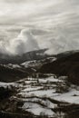 Snowy valley under a cloudy sky