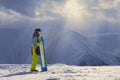 Snowy weather in the mountains snowboarder stands sideways