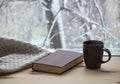 Snowy weather. Snow on trees and land. Bright white day. View outside the window sill with a cup of coffee and a book. And a warm Royalty Free Stock Photo