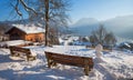 Snowy Weinberg hill with wooden benches, view to spa town Schliersee in winter Royalty Free Stock Photo