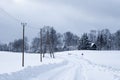 Snowy white road where along the edge runs Royalty Free Stock Photo