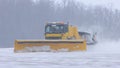 Snowy winter at the airport - a big snowplow removes snow from the path on the way