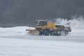 Snowy winter at the airport and snowplow removes snow