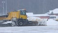 Snowy winter - a big snowplow removes snow from the path on the way Royalty Free Stock Photo