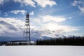 Snowy winter country with transmitters and aerials on telecommunication tower Royalty Free Stock Photo