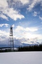 Snowy winter country with transmitters and aerials on telecommunication tower Royalty Free Stock Photo