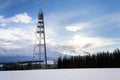 Snowy winter country with transmitters and aerials on telecommunication tower Royalty Free Stock Photo