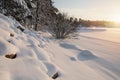 Snowy winter landscape at sunset.