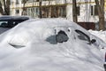 Snow covered the cars parked near the house. Royalty Free Stock Photo